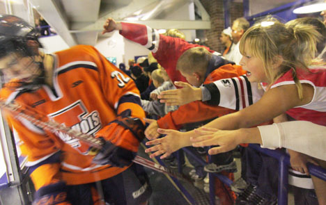 Ryley Parker, 6, reaches for Illinois club hockey player Alex Park as the team gets back on the ice for the second period of the game against Oakland University at the Illini Ice Arena on Friday, Sept. 29, 2006. Illinois won their season opener, 7-2. Josh Birnbaum The Daily Illini
