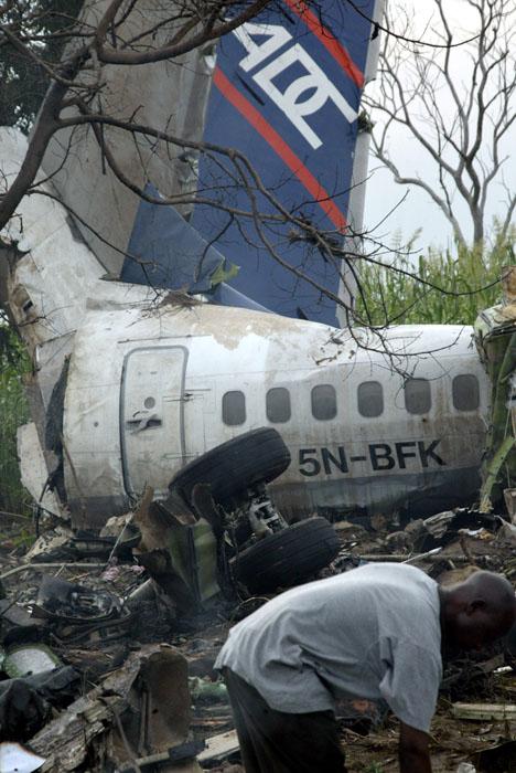 A man looks through the wreckage of a Nigerian airliner in a field in Abuja, Nigeria Sunday, Oct. 29, 2006. A Nigerian airliner carrying 104 people crashed in a storm Sunday just after taking off from the airport in the capital, and an aviation official s AP Photo/Sunday Aghaeze
