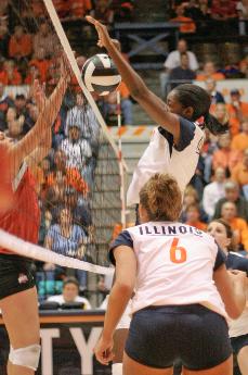 Junior middle blocker Vicki Brown jumps for a block as junior outside hitter Amy Palash watches during the final game in the three game sweep over 16th ranked Ohio State at Huff Hall, Oct. 13. John Paul Goguen, The Daily Illini
