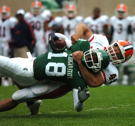 Brad Vest The Daily Illini Illinois Kyle Knezetic pulls down Michigan States Terry Love after an Illinois kick. Illinois punted the ball away 5 times in Saturdays game September 30, 2006 and forced Michigan State to punt 6 times.
