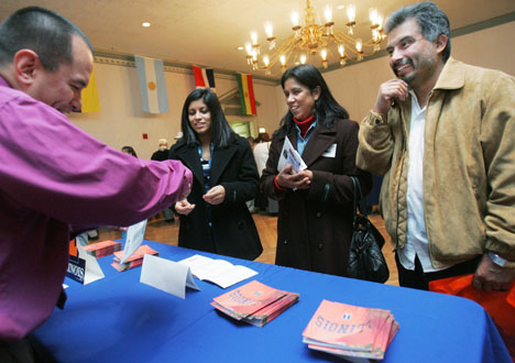 Abel Montoya of the Office of Admissions and Records, left, speaks to Natali Marquez-Ponce, center, freshman in LAS, and her parents, Maria Ponce and Leobardo Ocampo, at the Latino/a Family Visit Day activities in the Illini Union in Urbana on Sunday morn Josh Birnbaum The Daily Illini
