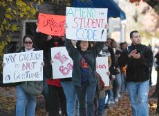 In front, Teresa Ramos, graduate student, marches down Fourth Street in front of the ZBT house to protest the Tacos and Tequila exchange the fraternity held with the Delta Delta Delta sorority. Suzanne Stelmasek The Daily Illini
