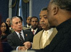 New York City Mayor Michael Bloomberg, left, shakes hands with New York City Councilman Charles Barron, as activist Rev. Al Sharpton, center, looks on following a meeting of Queens community leaders. The Associated Press
