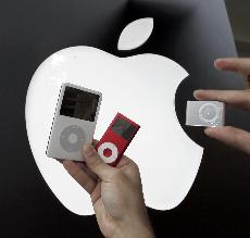 The new Apple iPod Shuffle, right, is shown next to a Red iPod Nano, center, and 60GB iPod, left, at an Apple store in Palo Alto, Calif., Nov. 3. The Associated Press
