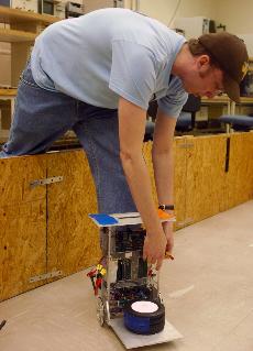 Graduate student Chris Graunke adjusts a SegBot for a trial run in the CAESAR Laboratory Wednesday afternoon at the Transportation Building. Dan Hollander
