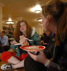 Maura Cotter, left, and Katie Prendergast, both freshmen in LAS, eat rice at the Hunger Banquet at the Illini Union on Tuesday, November 14. The banquet was organized in order to bring awareness about poverty, free trade and volunteer opportunities to stu Roxana Ryan
