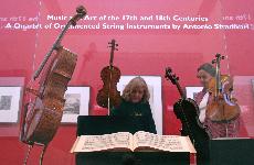 From left, Urbana resident Hilary Holbrook and her sister from California, Veronica Taylor, take a moment to look at the priceless set of instruments crafted by master builder Antonio Stradivari centuries ago that are on display at the Krannert Art Museum John Paul Goguen The Daily Illini
