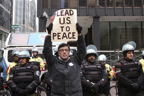 Malachi Ritscher holds up a sign during an antiwar protest in Chicago in this photo from April 2003. On Nov. 3, 2006, Ritscher set up a video camera, doused himself with gasoline and lit himself on fire on expressway off-ramp in downtown Chicago. War prot AP Photo/Joeff Davis
