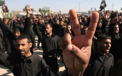 Members of the Mahdi army, followers of radical Shiite cleric Muqtada al-Sadr take part in a parade marking the seventh anniversary of the death of Muqtada's father Mohammed Sadiq al-Sadr, in Najaf, Iraq, Sunday, Nov. 26, 2006. (AP Photo/Alaa Al Marjani)
