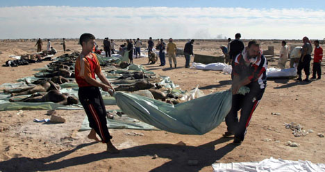 Iraqi volunteers carry wrapped bodies for their funeral in the Shiite holy city of Najaf, 160 kilometers (100 miles) south of Baghdad, Iraq, Friday, Nov. 10, 2006. The bodies of 176 victims of recent sectarian violence were brought from Baghdad to Najaf AP Photo/Alaa al-Marjani
