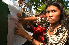 A Wayuu indigenous woman looks for her identification number on a voter list during presidential elections in Maracaibo, Venezuela, Sunday. The Associated Press
