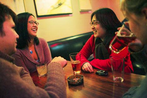 Jennifer Kim, second from right, laughs with friend Karla Melendez, second from left, both graduate students, at Cowboy Monkey in downtown Champaign on Friday night with friends Sara Beal, right, alumnus, and Andreas Ehmann, left, also a graduate student. Josh Birnbaum The Daily Illini
