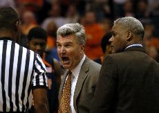 Illinois head coach Bruce Weber, alongside assistant coach Wayne McClain, speaks with officials after Weber received a technical foul during the game against Arizona at the US Airways Center in Phoenix, Ariz. Adam Babcock The Daily Illini
