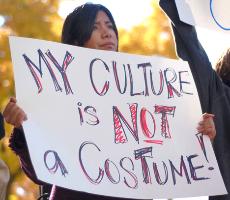 Senior in LAS Marlyn Rodriguez holds up a sign in support of the anti-racism rally organized by S.T.O.P. (Students Transforming Oppression and Privilege) on the Quad at noon on Oct. 31. The rally, which later moved to protest the Zeta Beta Tau fraternity Dan Hollander The Daily Illini
