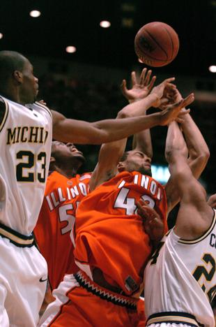 Shaun Pruitt, 55, and Brian Randle, 42, rebound the ball in the game against Michigan at Crisler Arena in Ann Arbor, Michigan, on Wednesday, Jan. 3, 2007. Illinois lost 71-61. Aaron Facemire, The Daily Illini
