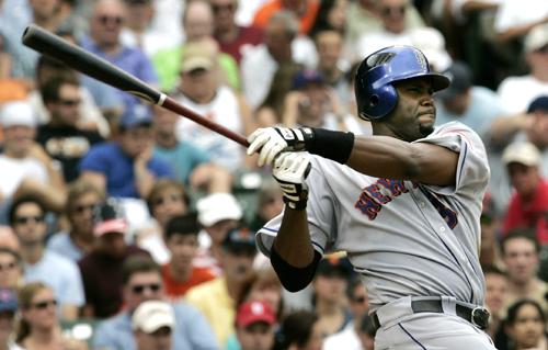 ** FILE ** New York Met Cliff Floyd launches a RBI single off Chicago Cubs Greg Maddux during the fourth inning of their game against at Wrigley Field in this July 14, 2006 file photo. (AP Photo/Charles Rex Arbogast)
