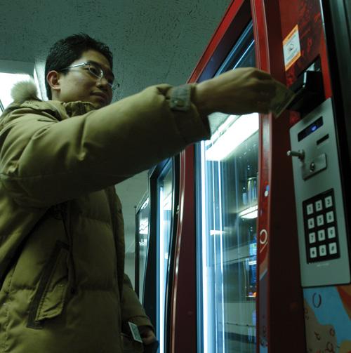 Dongwoon Kwak, 28-year-old architecture graduate student, buys soda from a vending machine in the basement of the Illini Union on Tuesday, January 16, 2007. Roxana Ryan
