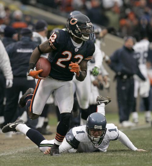 Chicago Bears kick returner Devin Hester (23) breaks away from Seattle Seahawks punter Ryan Plackemeier (1) while returning a kick in the NFC divisional playoff football game in Chicago, Sunday, Jan. 14, 2007. The play was called back because of a Bears p (AP Photo/Jeff Roberson)
