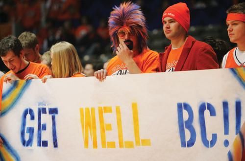 Members of the Orange Krush hold up signs in support of injured freshman Brian Carlwell before the game against Northwestern at the Assembly Hall on Sunday. The Illini won an ugly game, 48-37, behind swarming defense. ME Online
