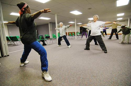 Left, Joyce Marie Hurd, of Champaign, leads stretching exercises during Fitness and Beyond at the Wellness Center of the First United Methodist Church at 210 W. Church St. in Champaign, Wednesday, Jan. 31, 2007. (The exercising) helps for both health a Joseph Lamberson
