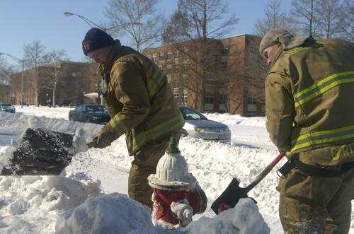 Urbana firefighters Keith Schafroth, left, and Greg Ritchie dig out the fire hydrant in front of ISR on Green Street Wednesday, February 14, 2007. Schafroth said they had been digging out hydrants for 3 and 1/2 hours before lunch, took a break, at went ME Online
