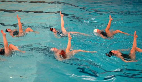 The synchronized swimming team practices at Freer Pool to the music of Russian composer, Rachmaninoff, during a two hour practice Sunday night in Urbana. Beck Diefenbach
