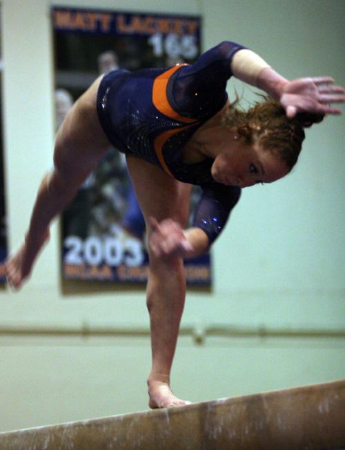 Illinois gymnast Julie Crall performs on the balance beam during the meet at Huff Hall on Sunday. Scoring 9.875 on the beam with a first place finish, Crall helped Illinois take second place overall at the meet. ME Online
