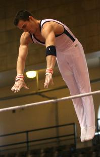 Illinois gymnast Wes Haagensen performs on the horizontal bar during the meet against Iowa at Huff Hall on March 3. Haagensen took first on the horizontal bar with a score of 9.4. Beck Diefenbach
