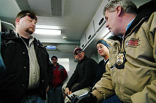 Left, Sgt. Scott Friedline, of the Champaign Police Department, meet with police officers from various local and state departments to discuss their techniques for recognizing potential citations in an Illinois State Police van, parked on the corner of 6th ME Online
