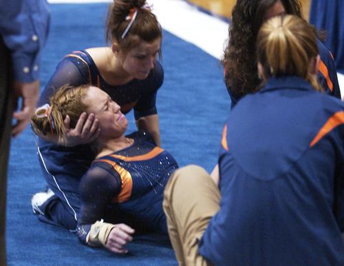 Illini gymnast Michelle McGrady is comforted by teammate Kimberly Kruk and others after being injured in the meet against Auburn on Friday March 9, 2007 at Huff Hall. ME Online
