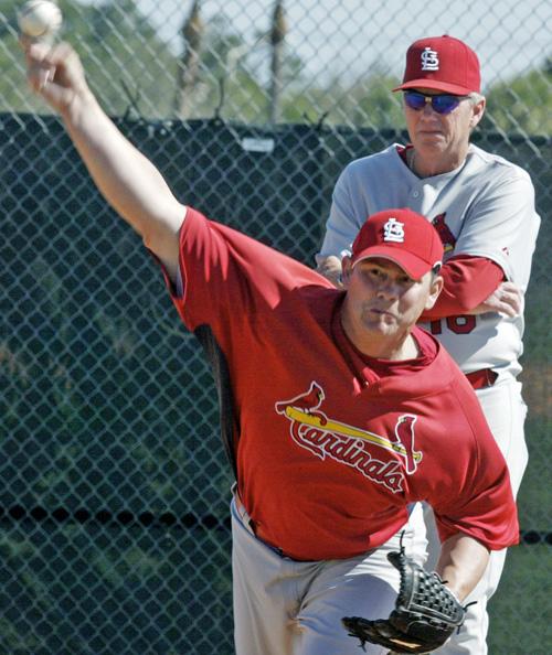 St. Louis Cardinals relief pitcher Jason Isringhausen pitches in the bull pen area at Roger Dean Stadium in Jupiter, Fla., with baseball pitching coach Dave Duncan watching Tuesday. Isringhausen had off season surgery. The Associated Press
