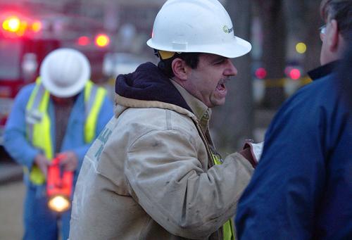 Ameren IP employees, center and left, talk with University Management Engineer Keith Erickson at the scene of an under-ground electrical disturbance outside of Sherman Hall at 909 S. Fifth St. on Thursday March 15, 2007. An underground wire popped and cau ME Online

