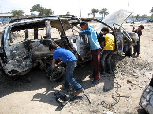 Young Iraqi boys examine a car, destroyed in an overnight raid, near the house of a close aid of anti-U.S. radical cleric Muqtada al-Sadr, Mohammed al-Tabatabaie, in Kufa, Iraq, Tuesday. The Senate narrowly approved a timeline to withdraw troops by March The Associated Press
