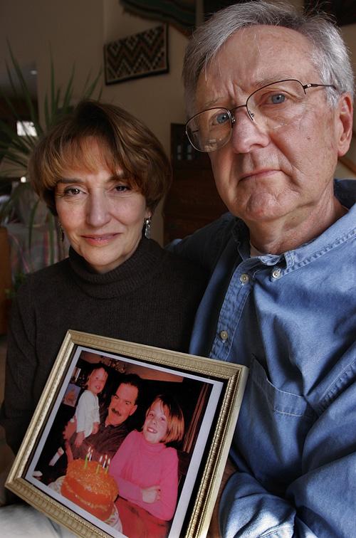 Alan and Glenna Weith hold a photo of son Linc Morris and his daughters Annalise, left, and Olivia, right, at their home in Mahomet, Ill., Friday, March 9. The Associated Press
