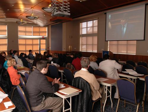 Campus and community members gather at the Alice Campbell Alumni Center to watch a televised speech by Governor Rod Blagojevich outlining his proposals for the fiscal 2008 budget. This was one of 15 sites across the state where people were invited to wat ME Online
