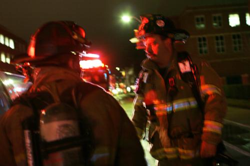 Firefighters discuss a fire that occurred in the Animal Sciences Lab on Gregory Drive in Urbana on Wednesday night. They were waiting to contact the professor who operates the lab to find out the actual cause of the fire. ME Online
