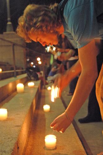 Chad Warner, junior in LAS, lights his candle at the candlelight vigil in memory of the victims of the Virginia Tech shootings in front of Foellinger Auditorium on Monday night. The candlelight vigil was sponsored by Chi Omega Sorority. Beck Diefenbach
