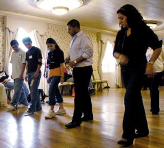 Barbara Paz Cornejo (far right) and Eric Tellez (right), both seniors in LAS, teach basic steps of salsa dancing to hispanic students from local high schools at the Latina/Latino Youth Conference Thursday. The students from three local high schools attend Beck Diefenbach
