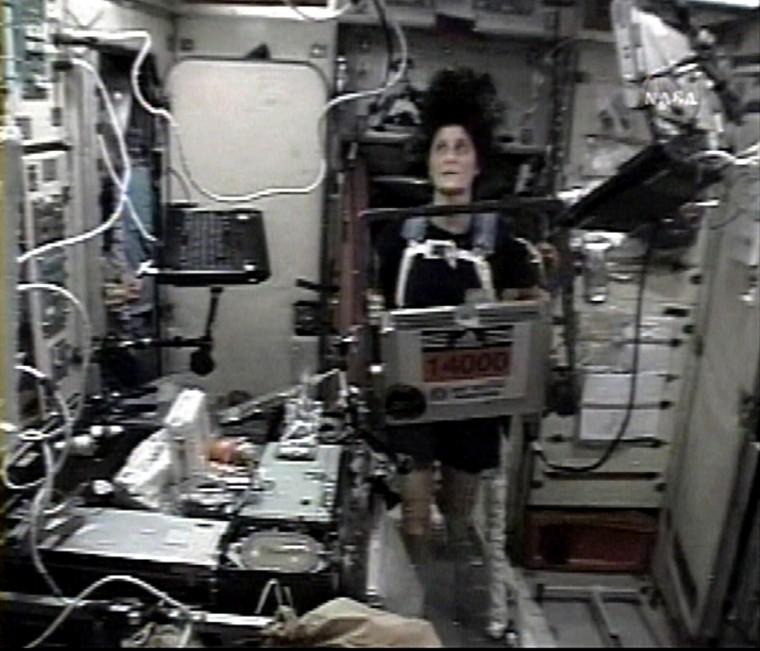 In this image from NASA TV, astronaut Sunita Williams runs on a treadmill with her Boston Marathon number 14000 displayed on the International Space Station, Monday. The Associated Press
