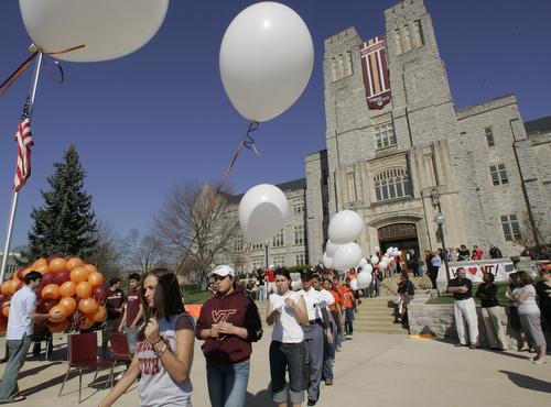 Students and staff members carry white balloons to the memorial service for the slain students and faculty on the campus of Virginia Tech in Blacksburg, Va., Monday. Charles Dharapak, AP
