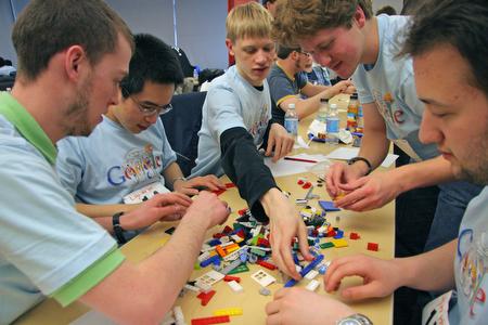 From right, juniors in Engineering Chris Re, David Grayson, Alan Lynn, Kevin Chang, and Ryan Mulligan, work collectively on their Lego bridge during a contest at the Google Games. The event, planned by engineering students and Google staffers, took place Beck Diefenbach

