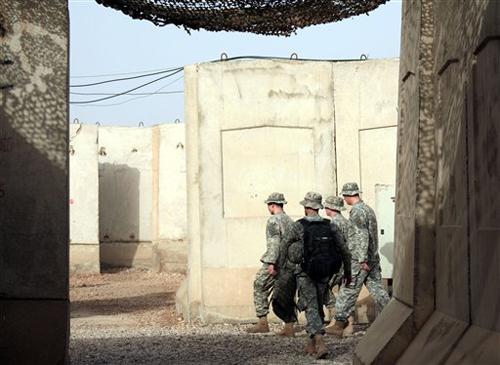 Soldiers pass through a maze of concrete barriers at Camp Striker in Baghdad, Iraq ThursdayApril 26, 2007. Gen. David Petraeus, the top U.S. commander in Iraq, said Thursday that conditions in Iraq may get harder before they get easier and will require "a The Associated Press
