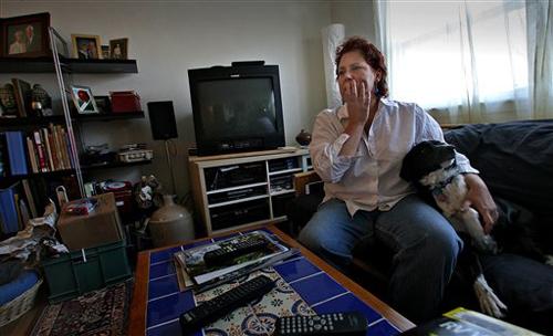 Seated with her dog, Dahlia, Lisa Perry, of St. Paul, Minn., pauses Saturday, April 7, 2007, while talking about the items she has posted for sale on internet auction site eBay. The Associated Press
