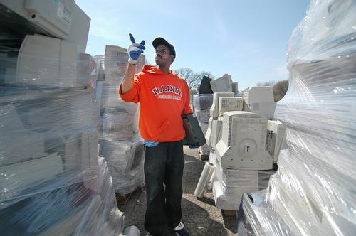 Muhammad Malik of Chicago navigates the forest of piled computers and monitors at the Champaign County Computer/Electronics Recycling Event at 1500 E. Main St., in Urbana on Saturday. I think scanners are over there, he said. Beck Diefenbach
