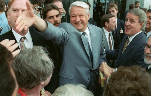 Russian President Boris Yeltsin reaches out to well wishers along with Canadian Prime Minister Brian Mulroney, right, in this June 19, 1992 file photo in Ottawa, Ontario, Canada. Fred Chartrand, AP
