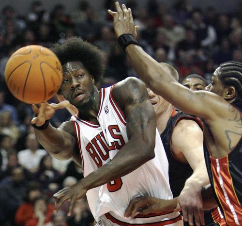 Chicago Bulls big man Ben Wallace, left, passes the ball during a game against the Miami Heat in Chicago on Dec. 27. Wallace will face his former team, the Pistons, in the playoffs. Nam Y. Huh, AP
