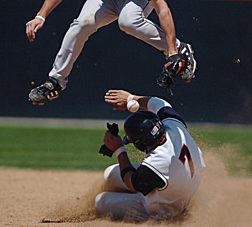 Lars Davis steals second base as a Minnesota player jumps to dodge him during the game at Illinois Field in Champaign on Sunday. Davis went 1-4 on Tuesday as the Illini downed the Salukis 13-5 in Carbondale. Beck Diefenbach
