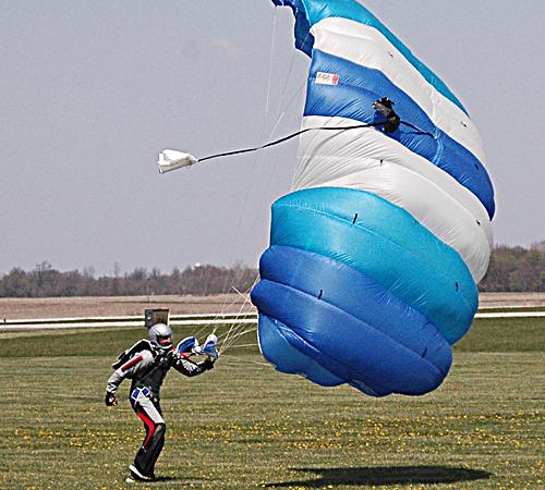 Don Doll fights with the wind to reel in his canopy after his 387th jump on April 15. Beck Diefenbach
