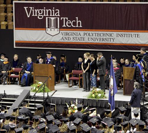 The family of slain Virginia Tech student Emily Jane Hilscher, sister Erica, left, and her parents Beth, and Eric, stand on the right side of the stage together as they are presented with a posthumous diploma for her during an undergraduate College of Agr The Associated Press
