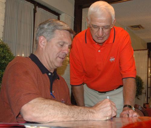 Ron Zook signs an Illini football poster for a fan at the Bloomington Country Club on Thursday, May 24, 2007. Steve Contorno
